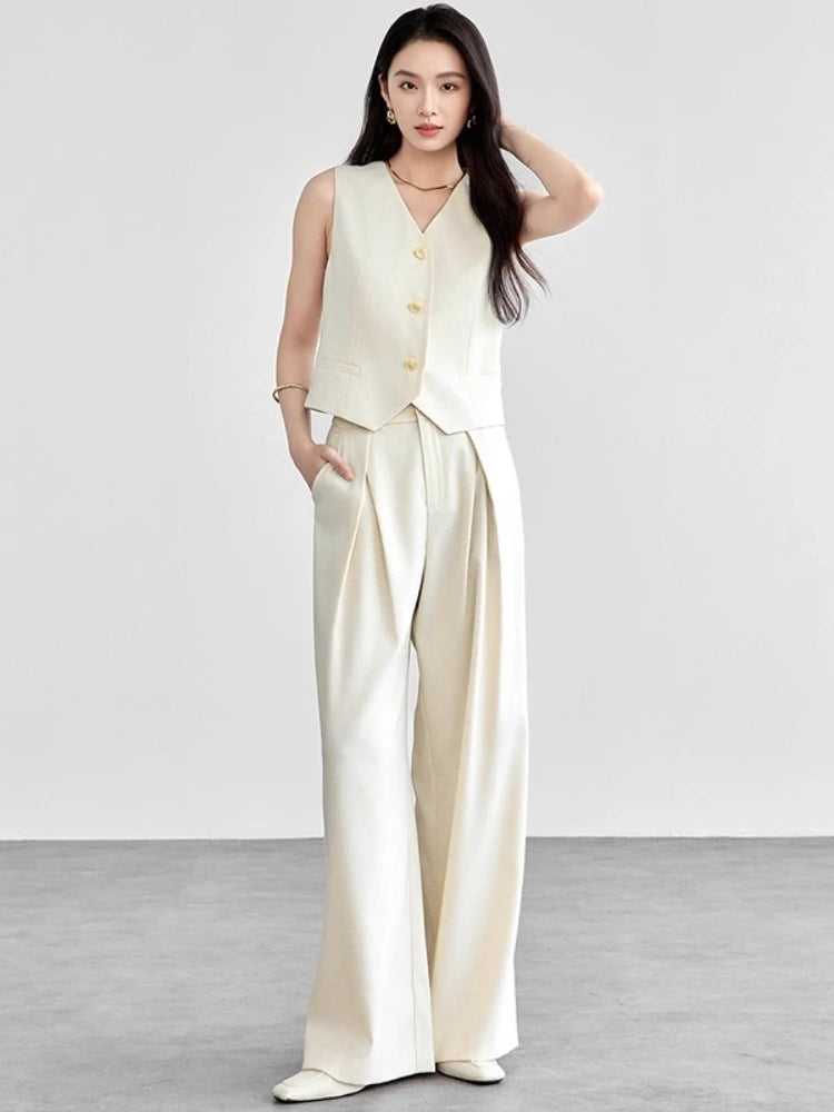 Women's two-piece linen blend set in C’est Ça color. Mid-waist trousers with crossed pleats, tailored V-neck vest with tone-on-tone buttons. — From Borcelleclothes.