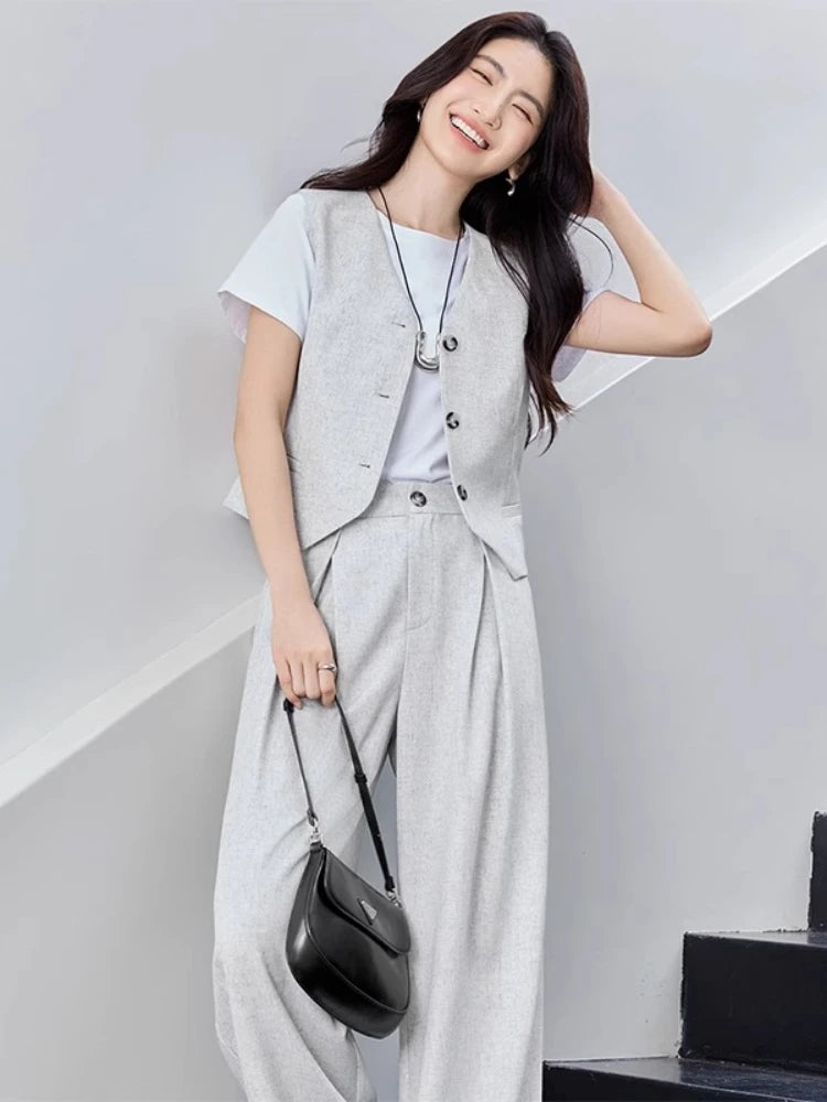 Women's two-piece linen blend set in First Light Rendezvous color. Mid-waist trousers with crossed pleats, tailored V-neck vest with tone-on-tone buttons. — From Borcelleclothes.