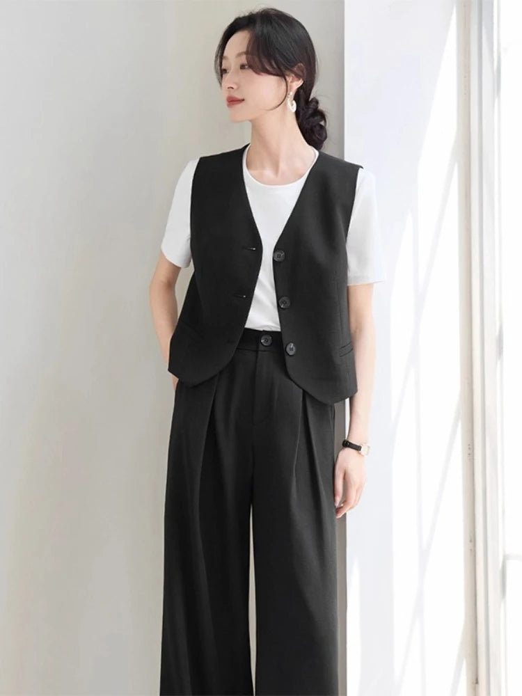 Women's two-piece linen blend set in Midnight Off-Duty color. Mid-waist trousers with crossed pleats, tailored V-neck vest with tone-on-tone buttons. — From Borcelleclothes.