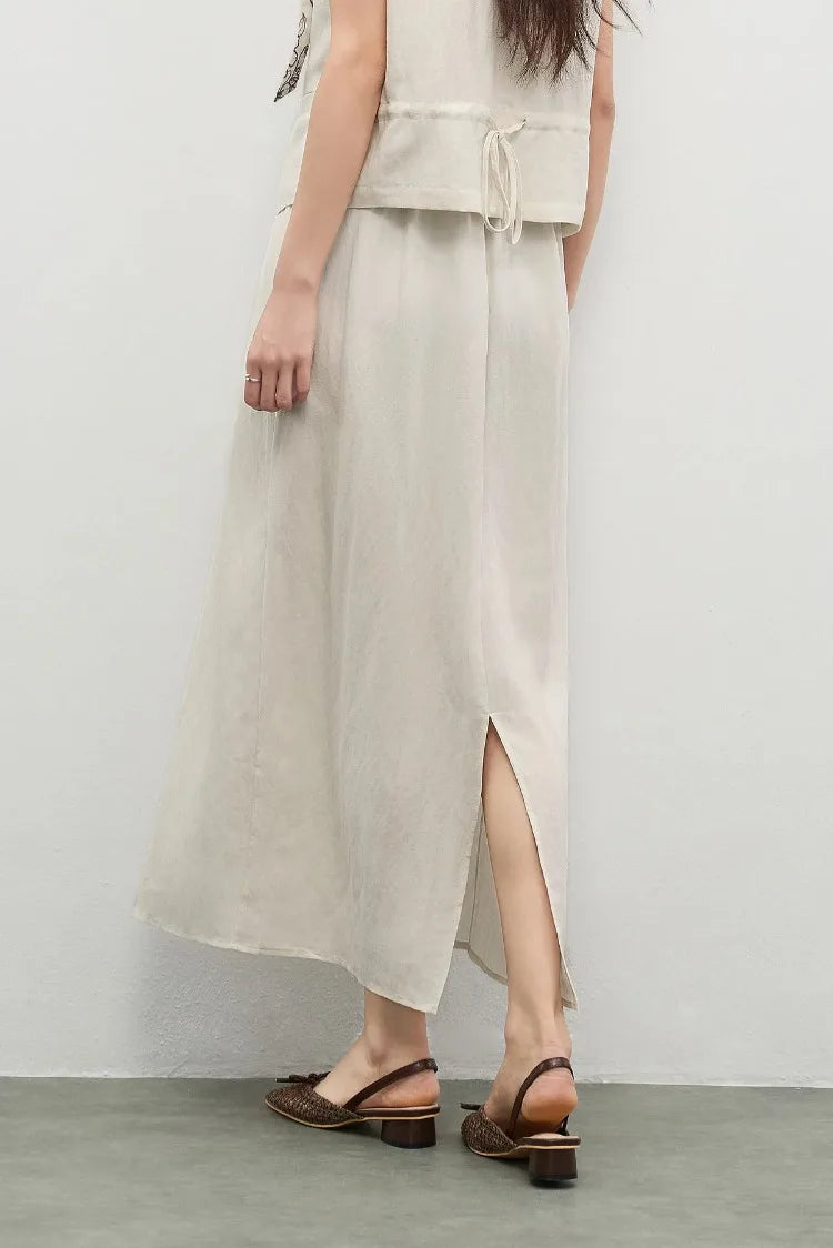 The back view of the pleated skirt, highlighting its elegant A-line shape — From Borcelleclothes.