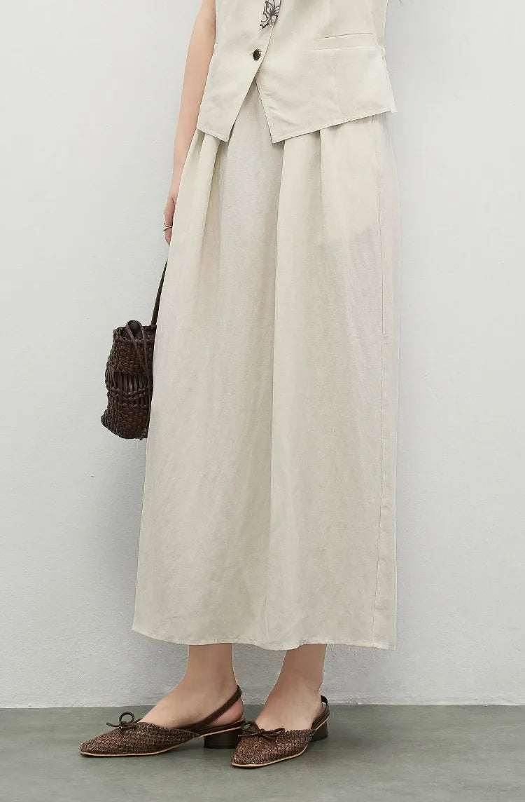 The fluid movement of the pleated lyocell skirt as the woman walks — From Borcelleclothes.