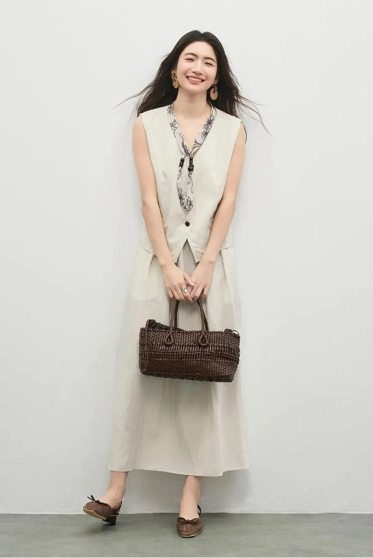 A light, joyful moment of a woman carrying her bag in a coordinated set — From Borcelleclothes.