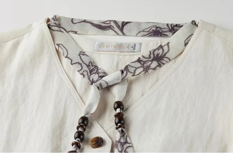 Close-up of the V-neckline featuring the delicate fabric tie — From Borcelleclothes.