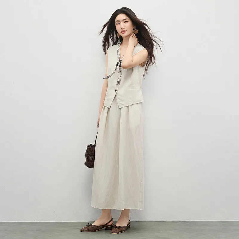 Two-piece set: V-neck vest with back drawstring and a pleated mid-calf skirt. Includes a fabric tie with wooden beads. — From Borcelleclothes.