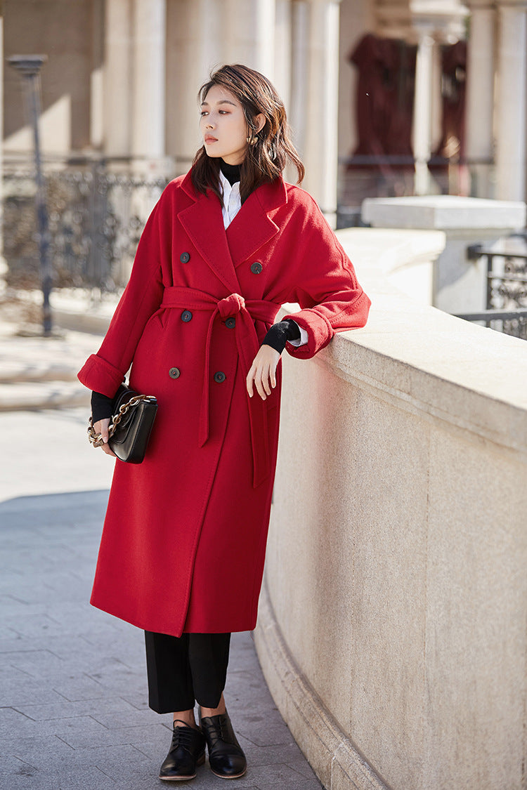 A secret pact with the sun: leaning against the stone parapet in the deep, matte red of Cinnabar Soul. From Borcelleclothes.