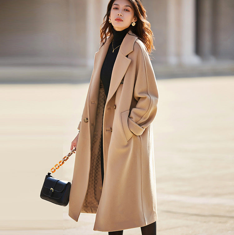 A practical yet elegant moment—hand in pocket, holding a leather bag in the warmth of French Beige. From Borcelleclothes.