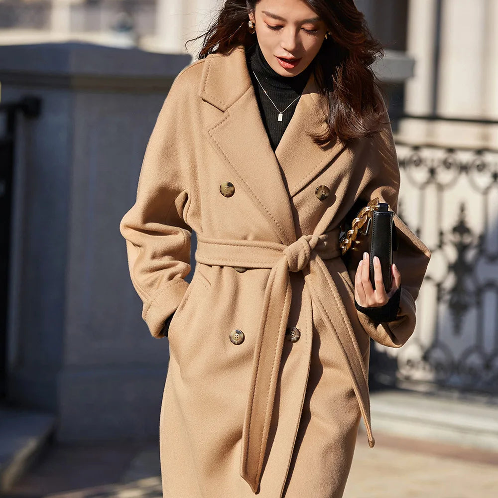The effortless grace of a woman in motion, her French Beige coat dancing with the spring breeze. From Borcelleclothes.