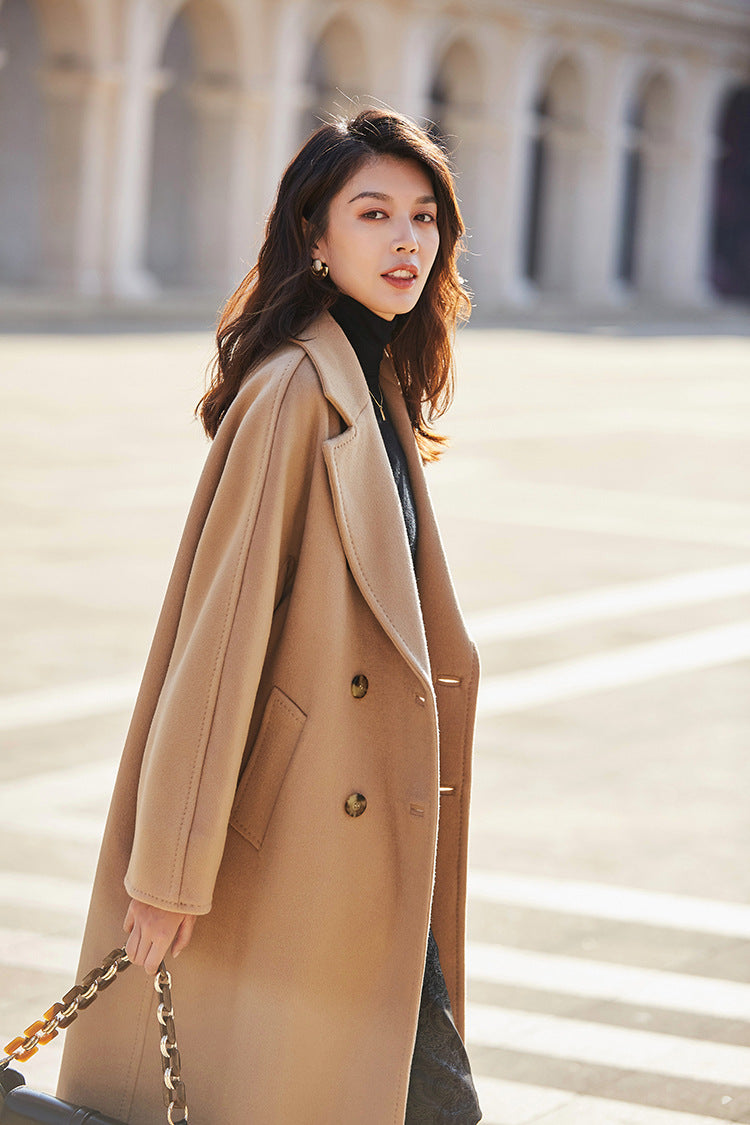 The fluid, cascading silhouette of the French Beige coat in motion as she explores the city. From Borcelleclothes.