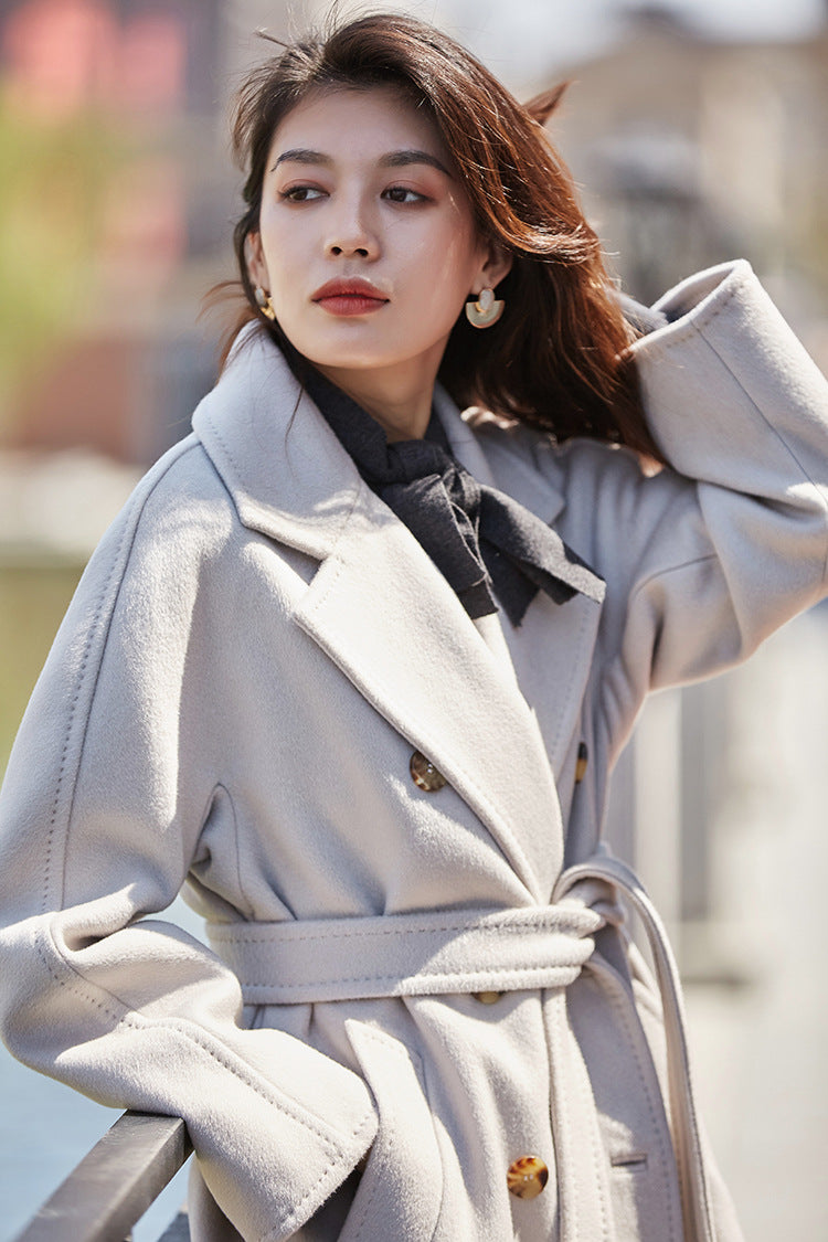 A delicate gesture—adjusting her hair while wrapped in the slate-grey shadows of Romantic Light. From Borcelleclothes.
