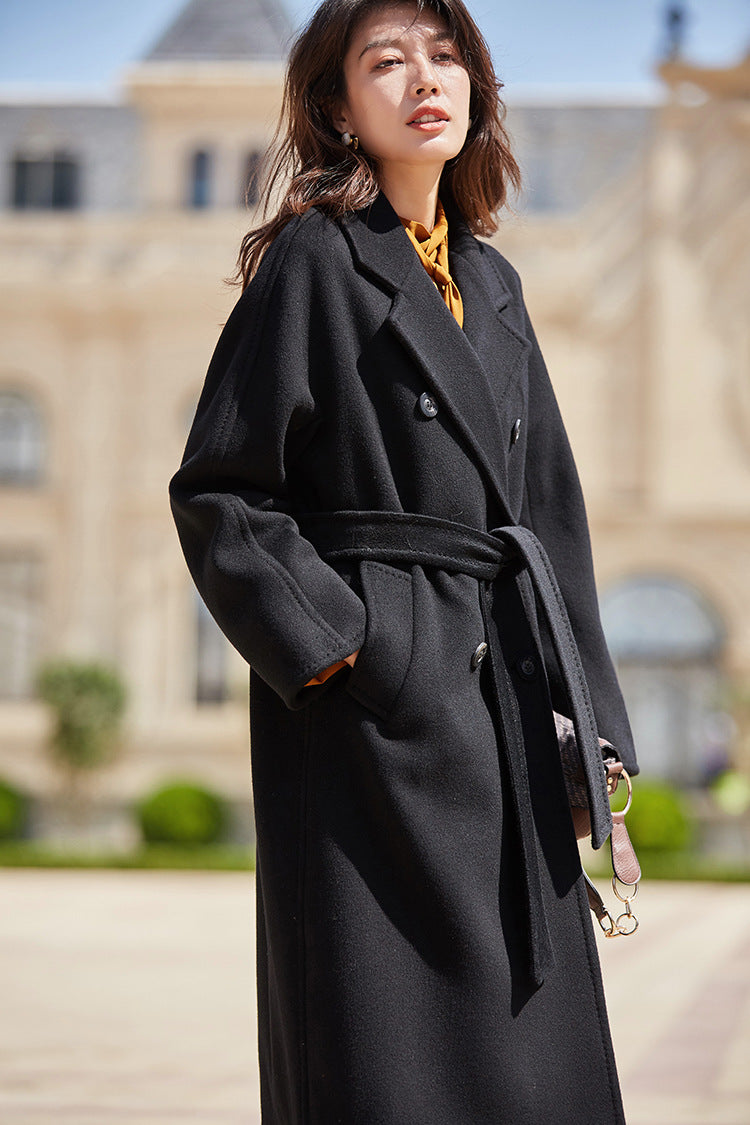 Self-assured and poised—the Signature Black coat drinks the sunlight as she stands ready. From Borcelleclothes.