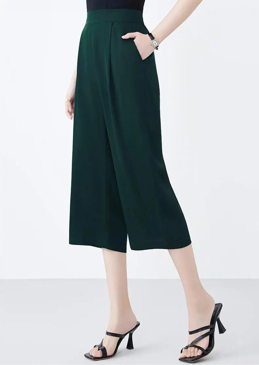 Side view of a model with a hand in the pocket of Cyber Jade Mulberry silk trousers — From Borcelleclothes.