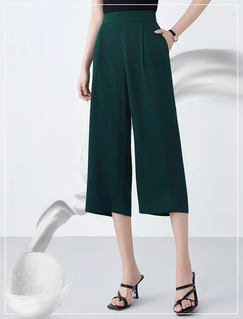 Model posing with a hand in the slash pocket of Cyber Jade silk trousers — From Borcelleclothes.