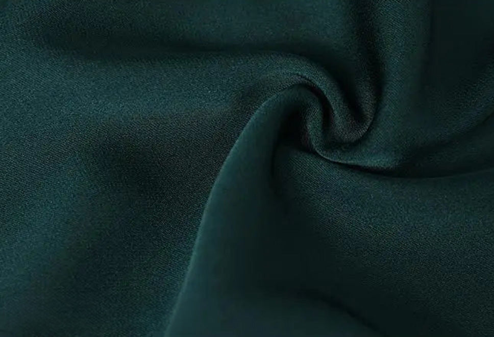 Close-up of the spiral folded fabric texture on Cyber Jade Mulberry silk trousers — From Borcelleclothes.