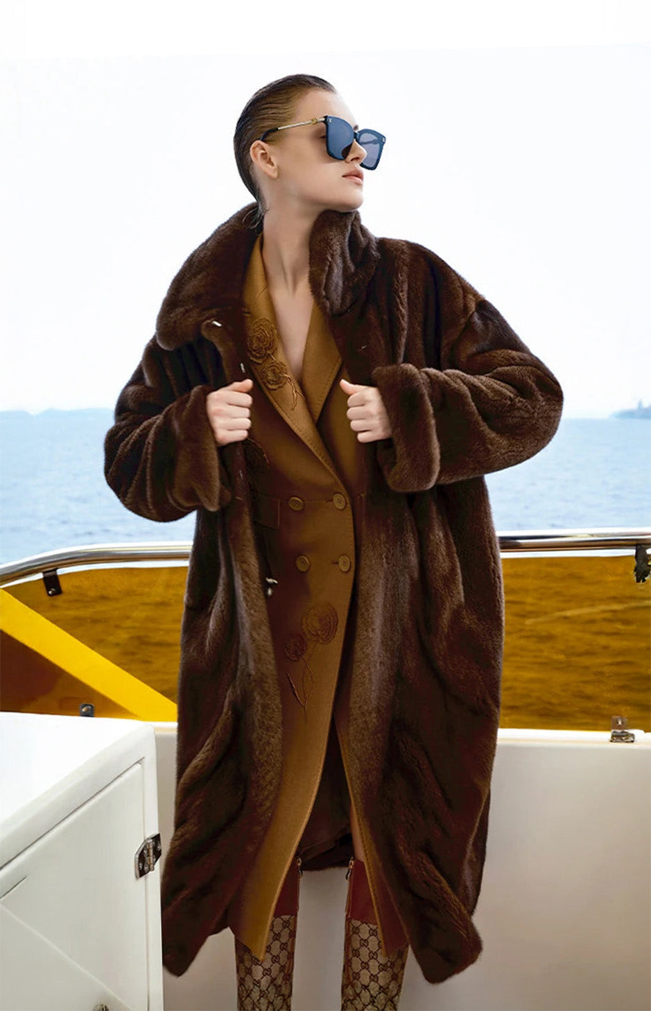 Unfastened Mirage of Marron mink coat, model holding front edges, full silhouette and vertical texture visible. — From Borcelleclothes.