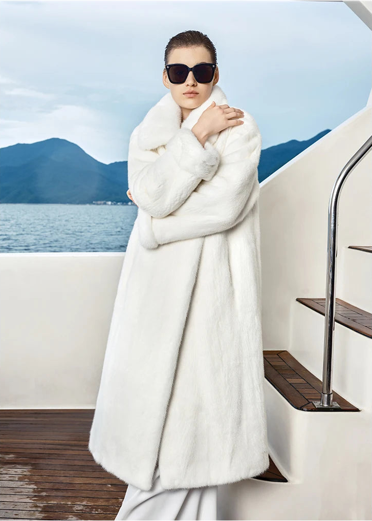 Model in White Echo mink coat resting hand on shoulder, highlighting soft structure and clean collar lines. — From Borcelleclothes.