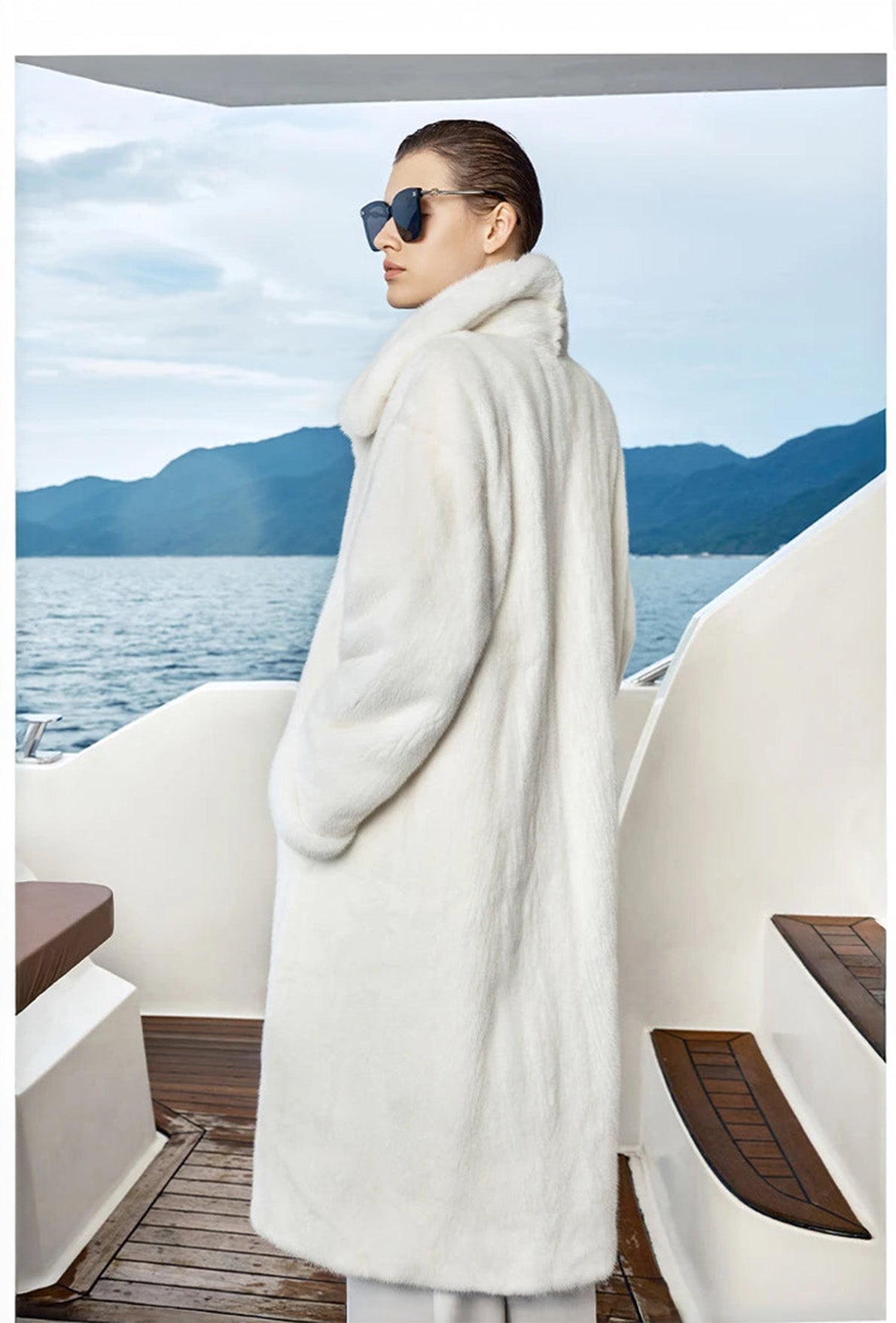 White Echo mink coat in profile, model standing with side view emphasizing minimalist straight cut. — From Borcelleclothes.