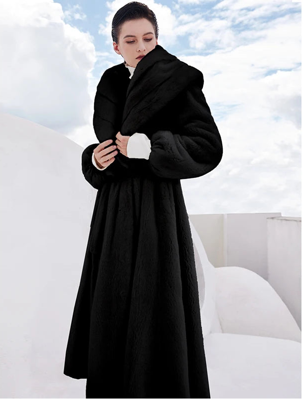 Women’s wrap mink coat with a generous shawl collar and self-tie belt, in Au-Delà Du Noir color, featuring a flared silhouette and calf length — From Borcelleclothes.