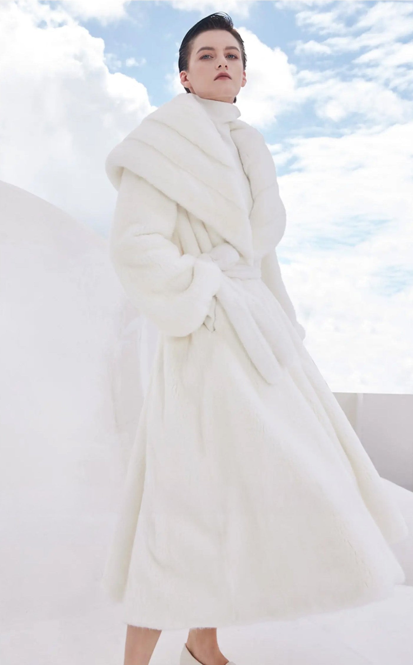 Model wearing the white mink coat Donne-Moi Ton Cœur, body turned slightly to the side — From Borcelleclothes.