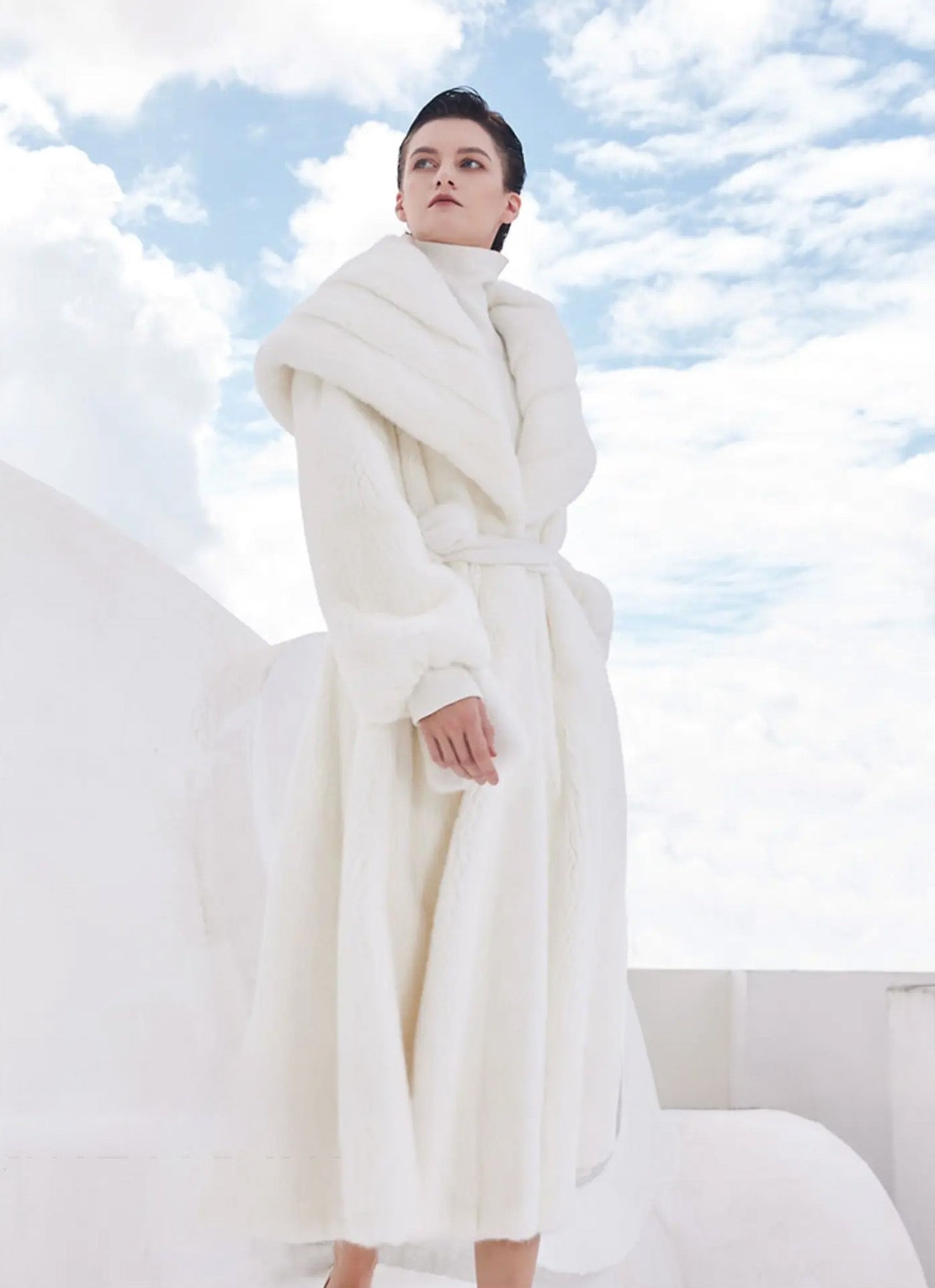 Model walking forward in the Donne-Moi Ton Cœur coat, with flared hem in gentle motion — From Borcelleclothes.