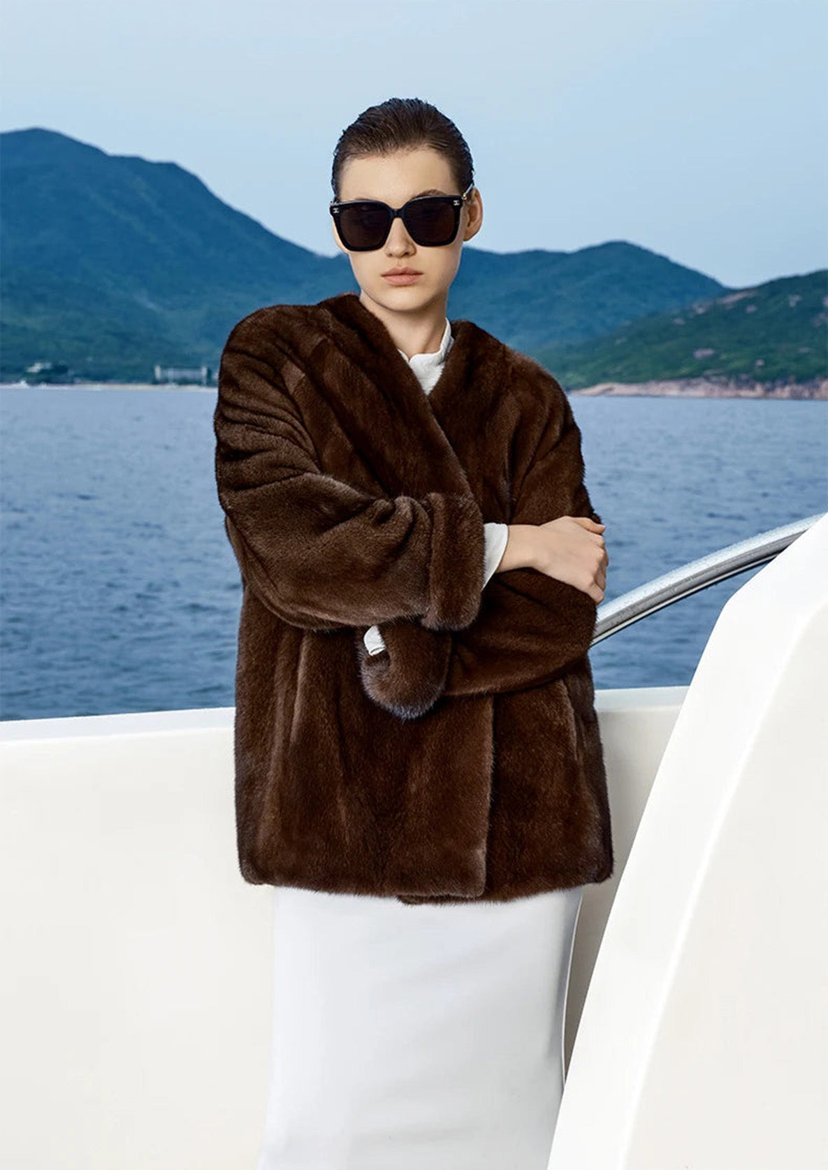 Close view of Trace of Clove mink coat with model’s hand resting at the elbow — From Borcelleclothes.