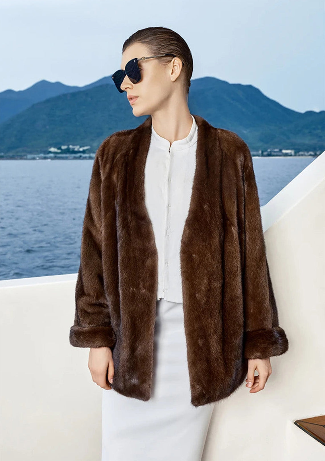 Model turning her head in Trace of Clove mink coat, revealing neckline and fur texture — From Borcelleclothes.