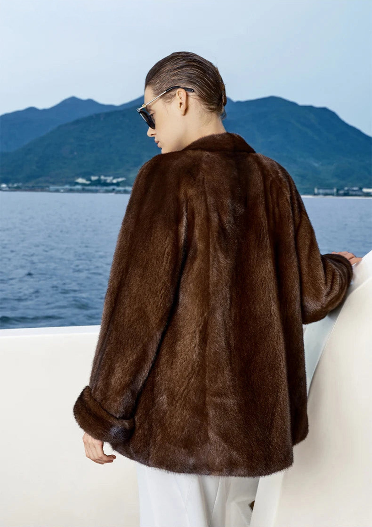 Unfastened Trace of Clove mink coat seen from the back, showing movement and structure — From Borcelleclothes.