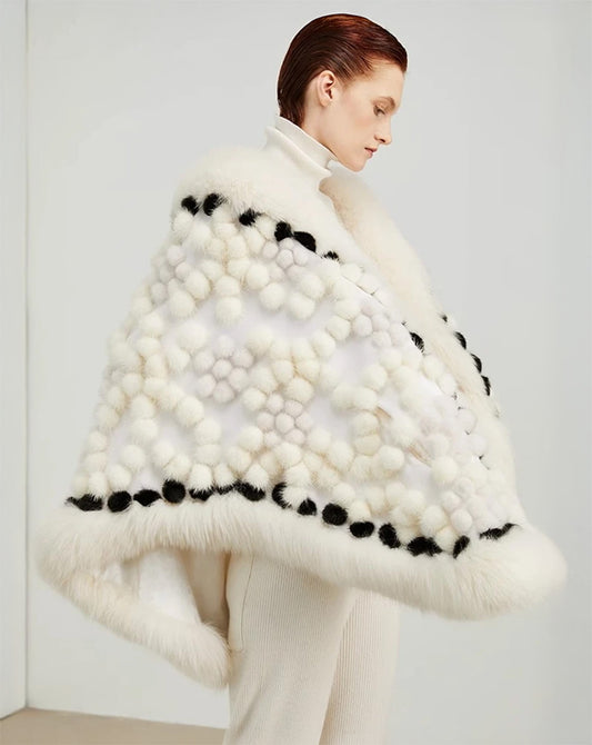 Women’s mink and fox fur shawl in De Ja Vu with Black Umber pompons. Velvet base, round silhouette, and scattered snowball texture. — From Borcelleclothes.