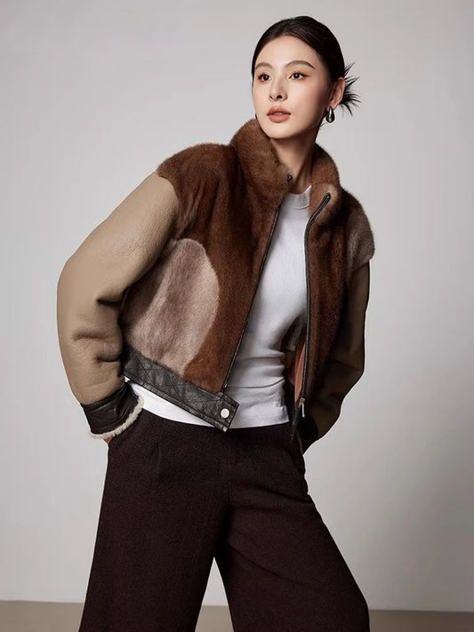 Women’s cropped jacket in Cardamon Spice, combining real mink and genuine shearling, featuring asymmetrical patchwork and quilted leather accents. — From Borcelleclothes.