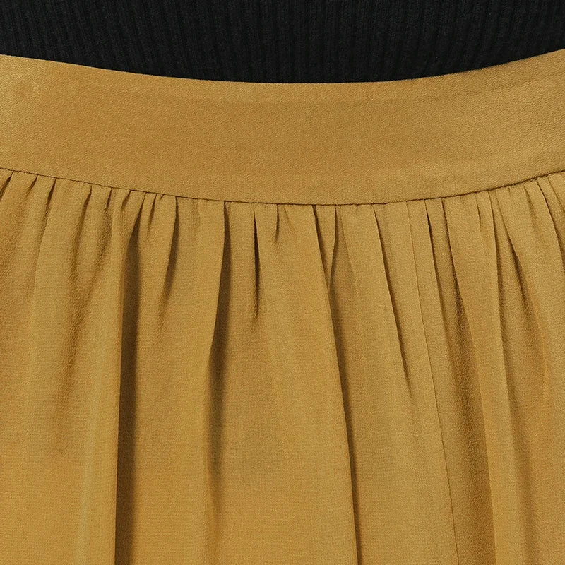 Close-up shot focusing on the clean, structured back waistband of the luxury silk skirt — From Borcelleclothes.