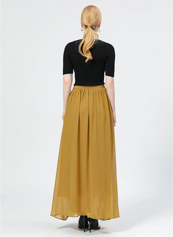 Back view of a model wearing the mid-calf silk wrap skirt in Aztec Gold, highlighting its elegant fit and flow — From Borcelleclothes.