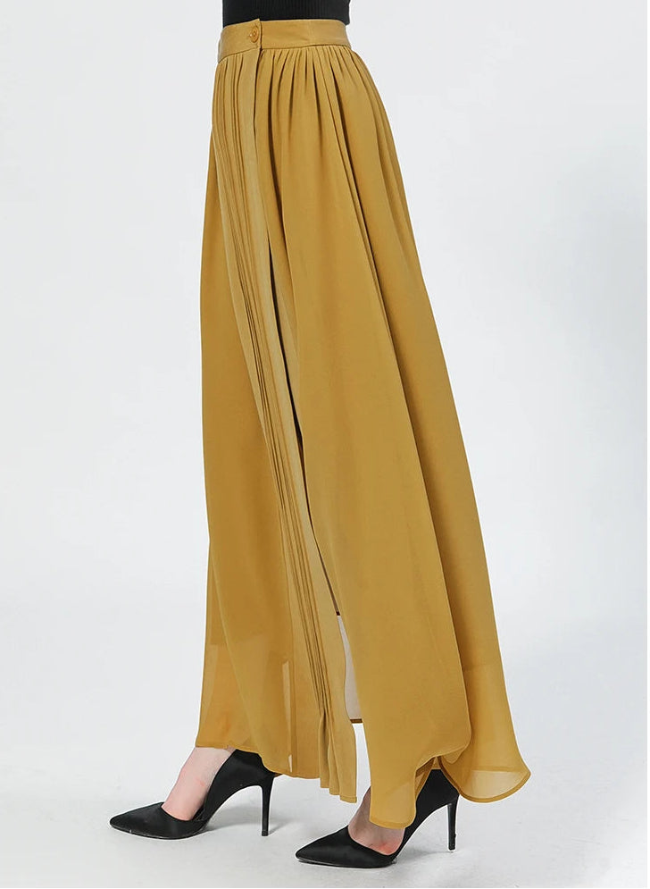 Elegant side profile of a model posing in the Aztec Gold silk wrap skirt with delicate pintucks — From Borcelleclothes.