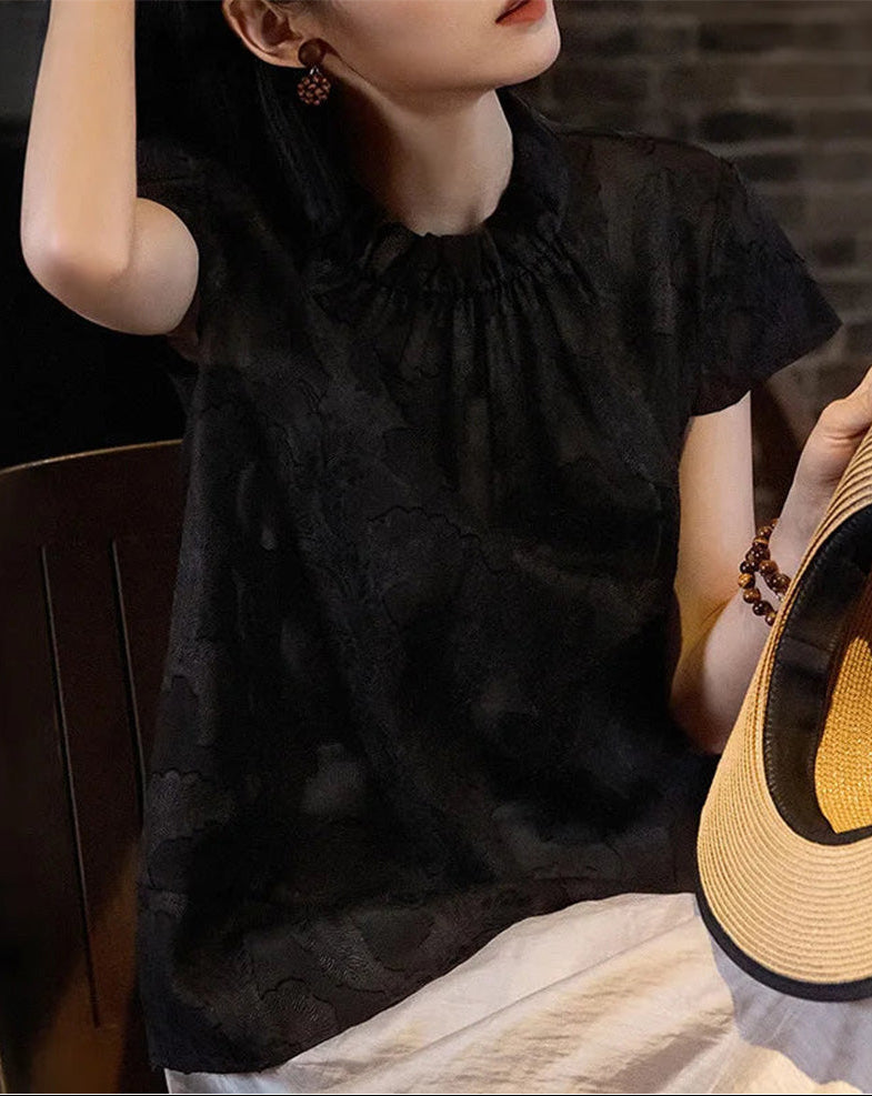 Women's Mulberry Silk Blouse in Bittersweet Noir — model adjusting her hair, showcasing the wide banded gathered neckline and relaxed drape — From Borcelleclothes.