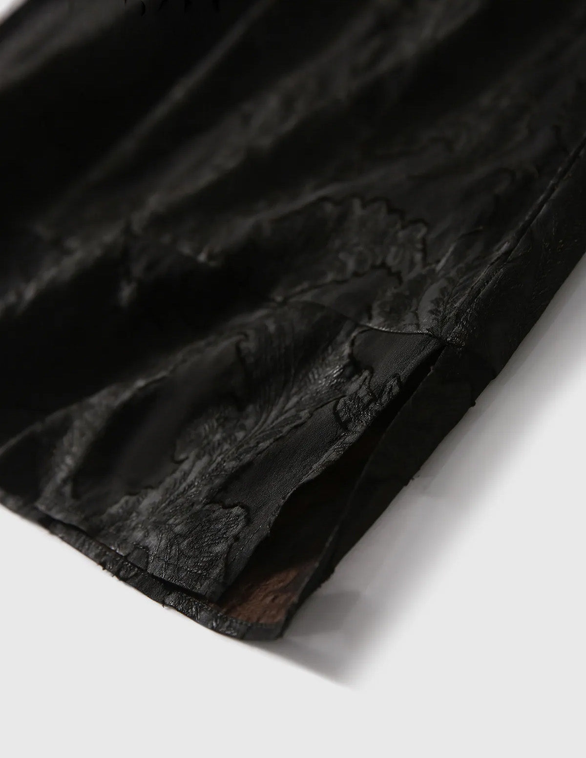 Close-up of the tailored side slit and straight hemline on the Mulberry Silk Blouse in Bittersweet Noir — From Borcelleclothes.