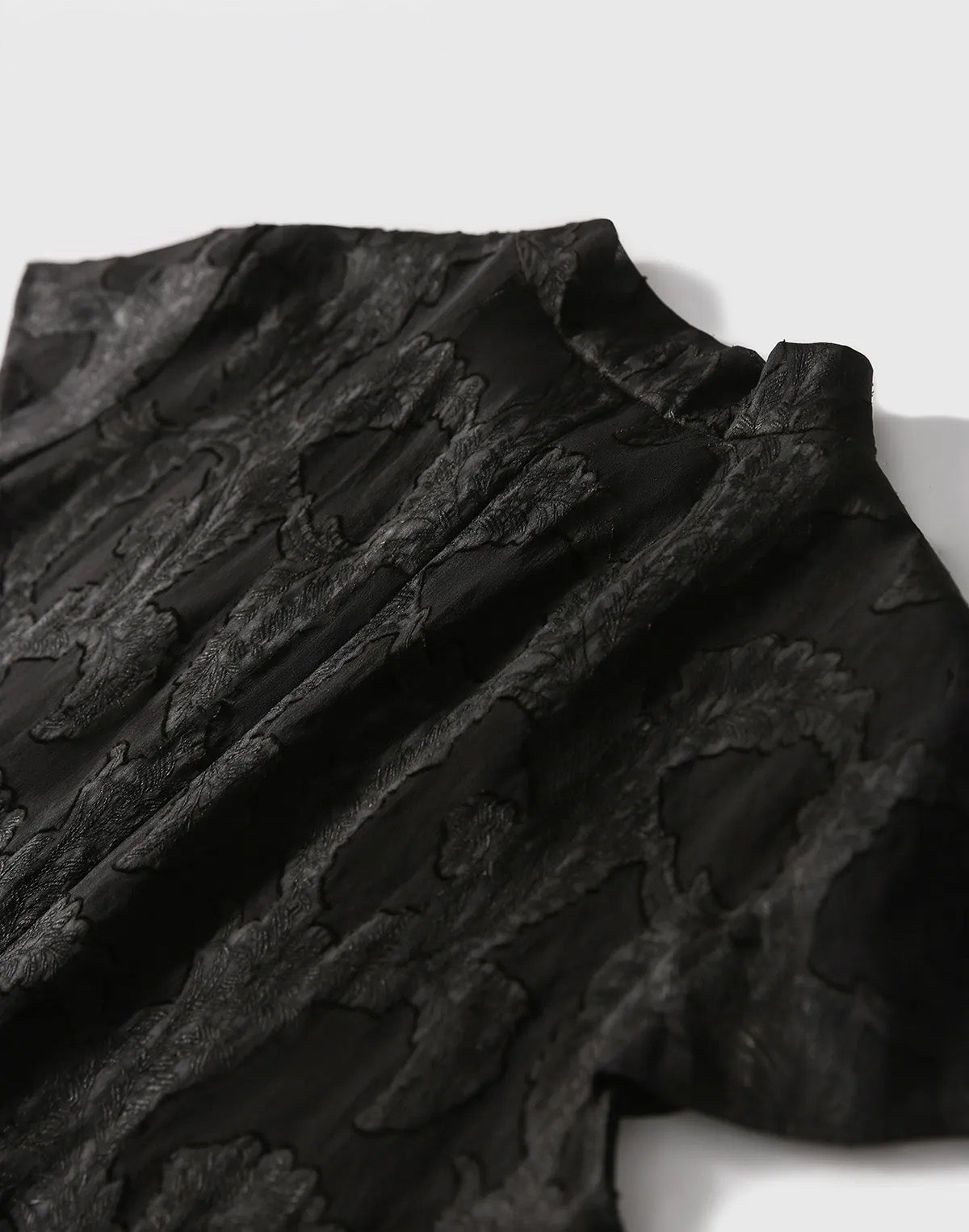 Back close-up of the Women's Mulberry Silk Blouse in Bittersweet Noir, displaying the clean neckline finish and subtle leaf relief — From Borcelleclothes.
