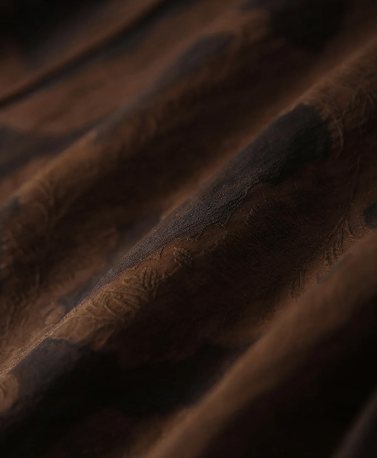 Draped view of the reverse side of the Bittersweet Noir silk fabric, highlighting the warm milk-chocolate hue and fine micro-vein structure — From Borcelleclothes.