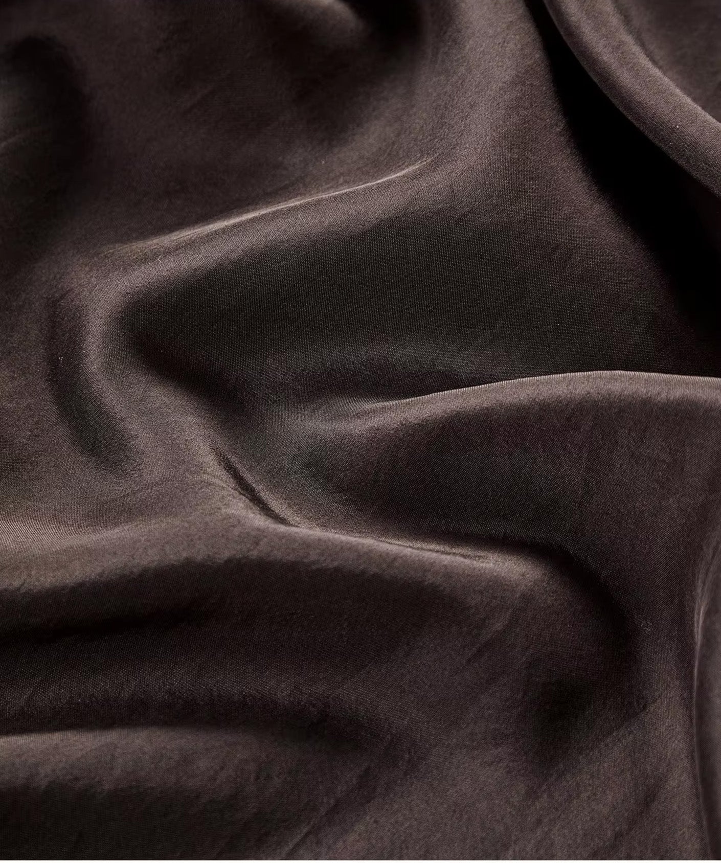 Close-up of premium Grade 6A Mulberry silk poplin fabric texture in Bitter Chocolate with soft folded waves — From Borcelleclothes.