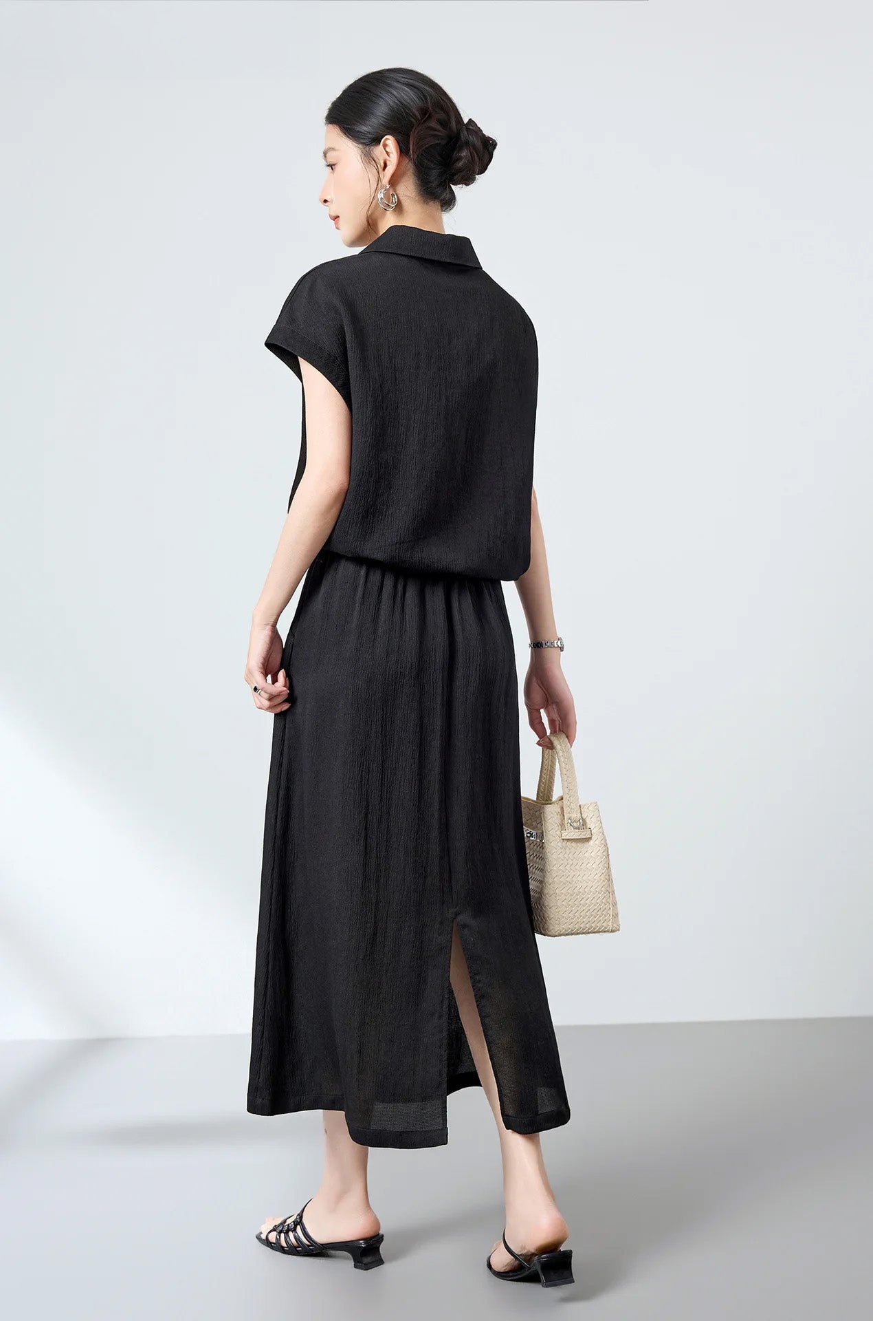 Back view of model wearing the loose-fitting Mulberry silk crinkled polo shirt in Melting Evening — From Borcelleclothes.