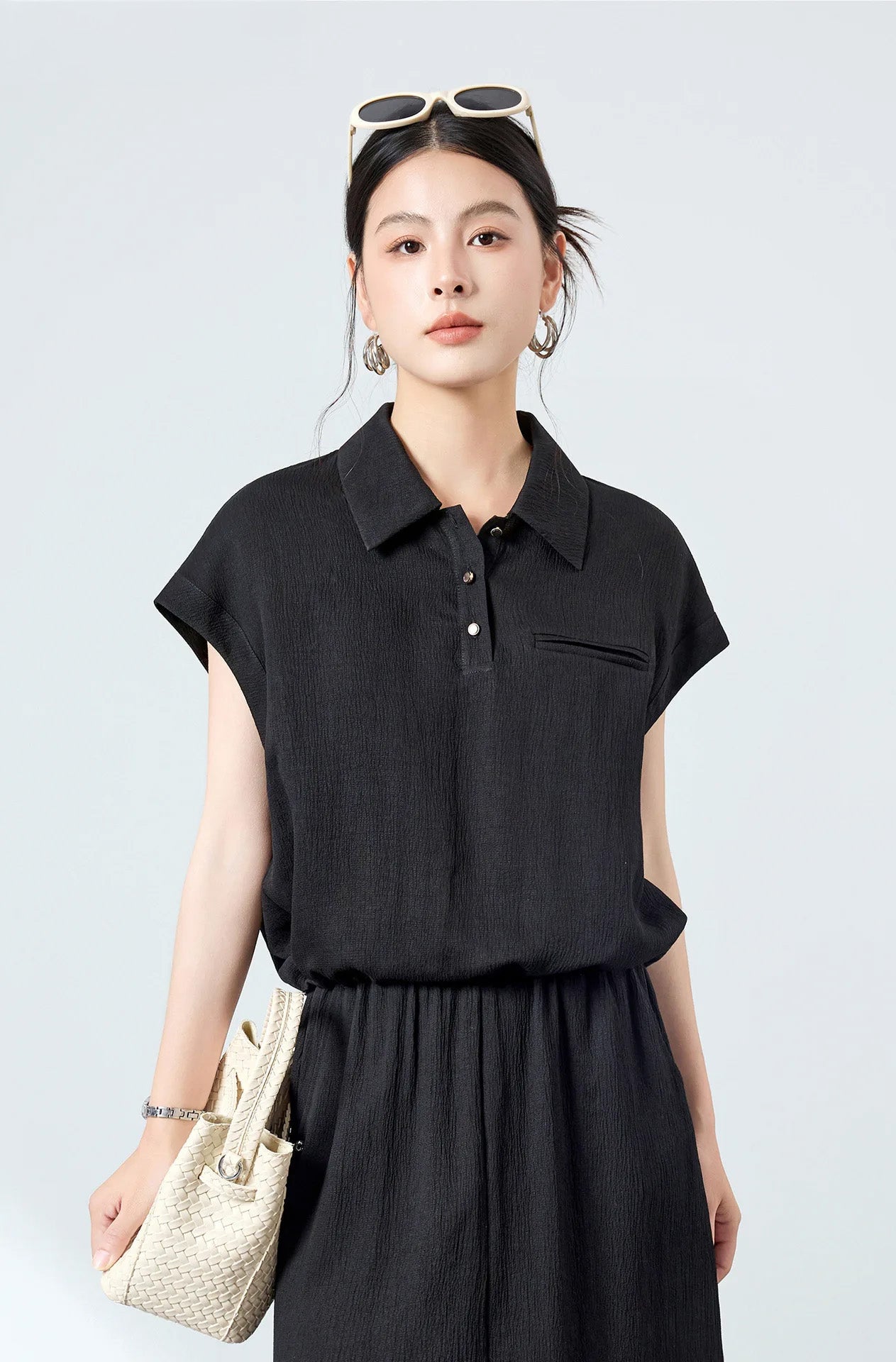 Model wearing the Melting Evening silk crinkled polo shirt, carrying a handbag for a modern workwear look — From Borcelleclothes.