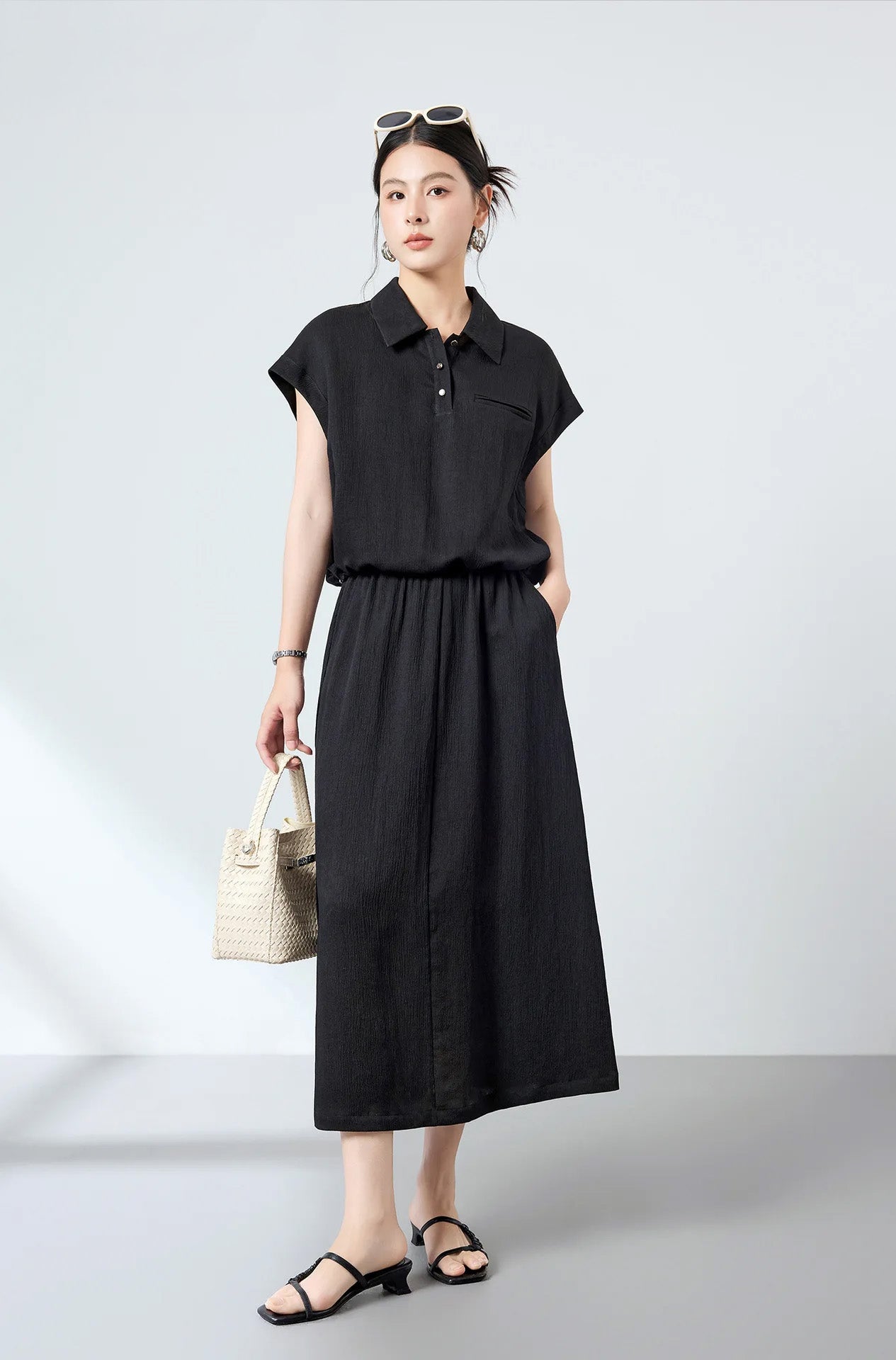 Full-length view of model posing in the Melting Evening Mulberry silk crinkled polo shirt paired with wide trousers — From Borcelleclothes.