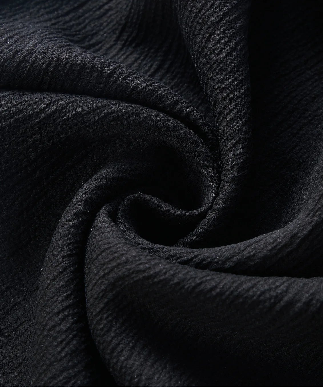 Detailed close-up of the 3D crinkled Mulberry silk fabric in Melting Evening, neatly spiral-folded — From Borcelleclothes.