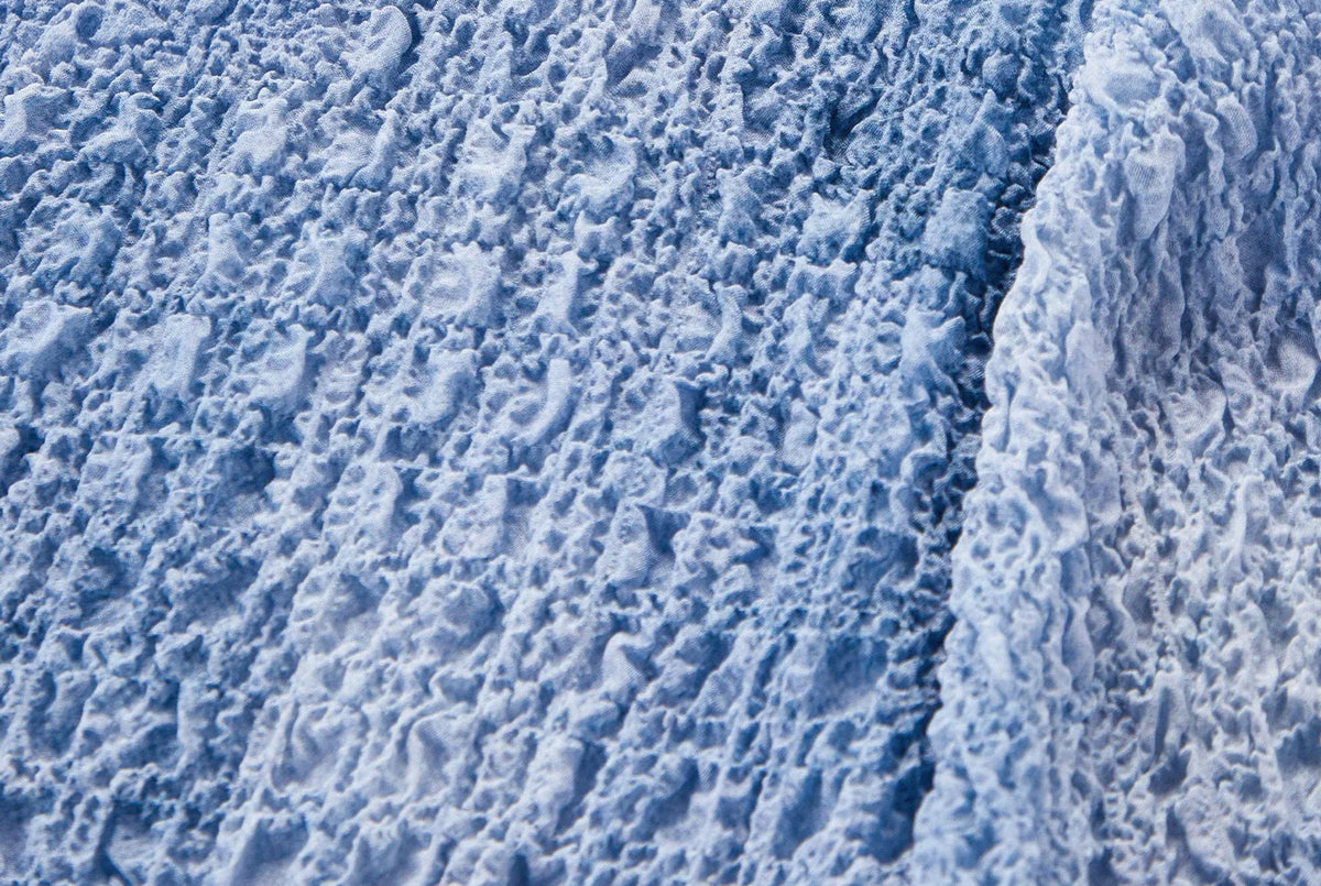 Close-up of the clean armhole seam craftsmanship on the Cloudy Sky puckered silk top — From Borcelleclothes.