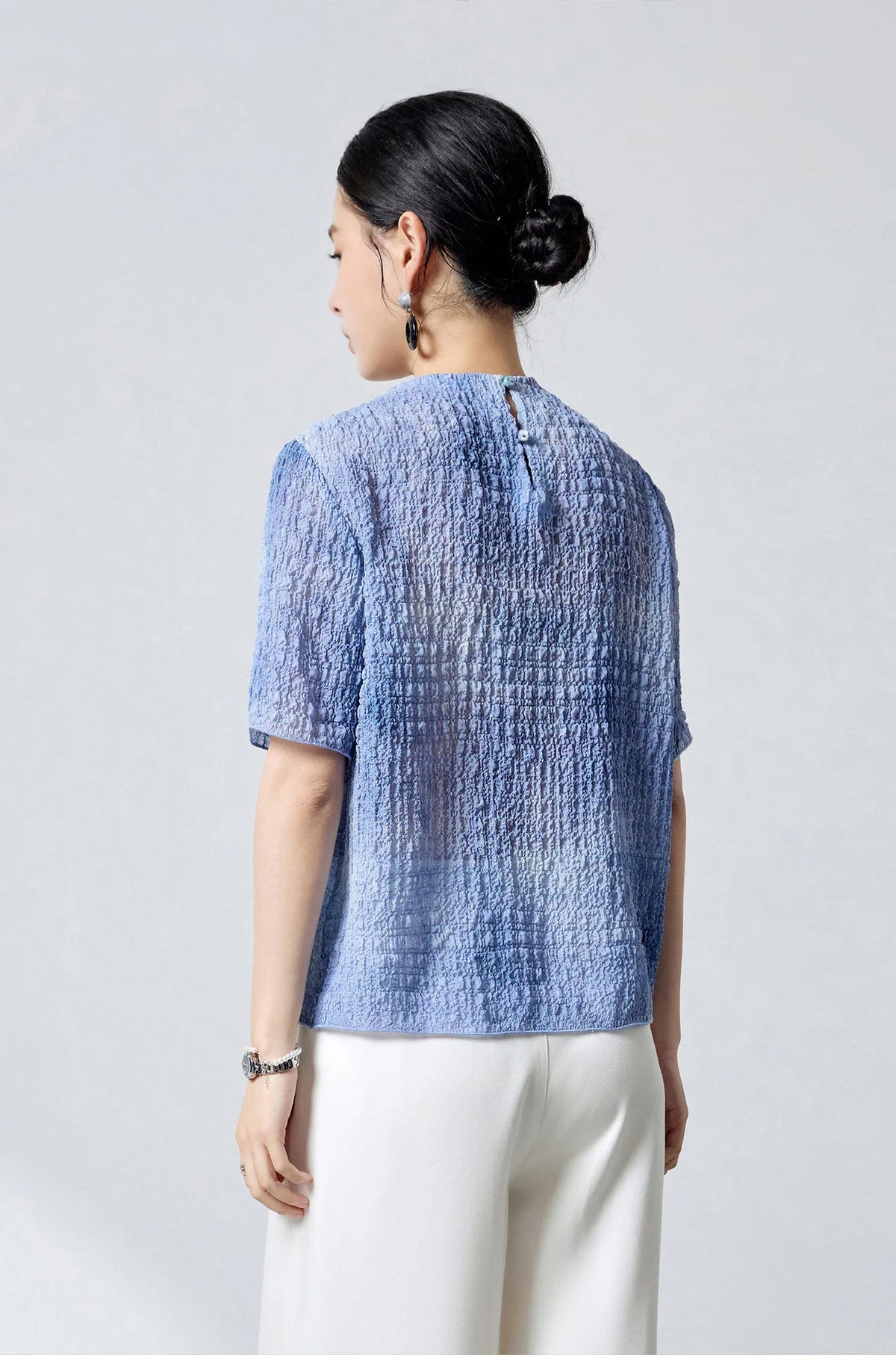 Rear view of the Cloudy Sky mulberry silk puckered jacquard top highlighting the back slit — From Borcelleclothes.