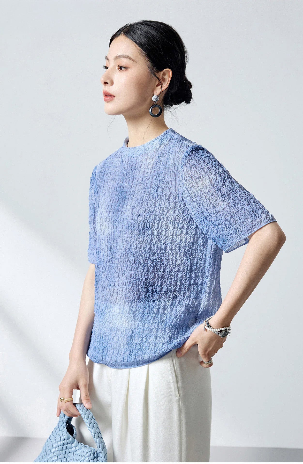 Three-quarter profile of the Cloudy Sky mulberry silk puckered top on a model — From Borcelleclothes.