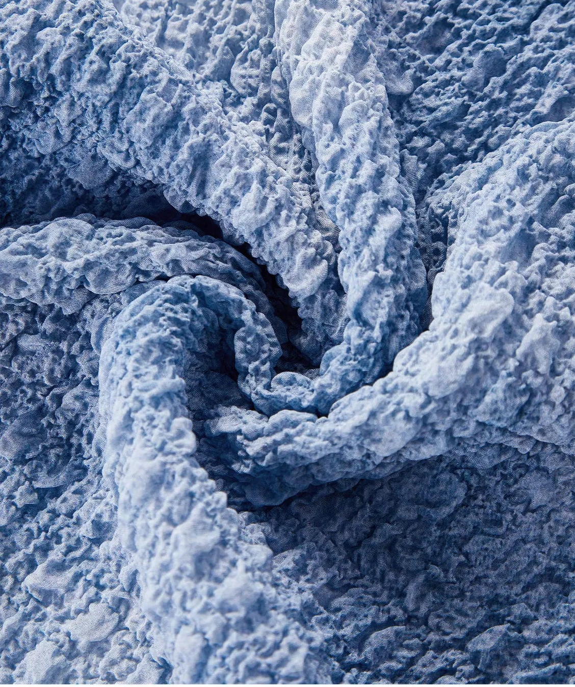 Spiral fold macro shot showcasing the Cloudy Sky 3D puckered mulberry silk jacquard texture — From Borcelleclothes.