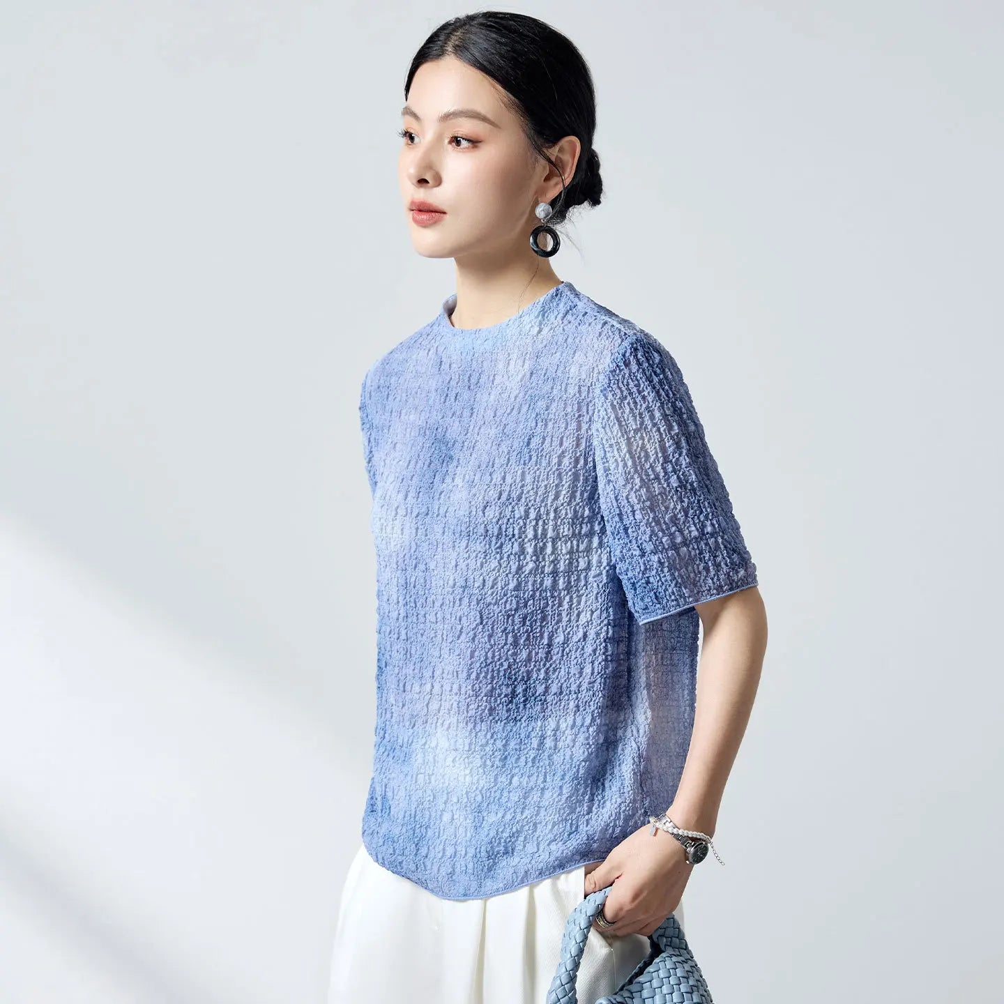 Women's Mulberry silk jacquard top in Cloudy Sky (18 momme). Features a 3D puckered texture, porcelain buttons, and a crease-free drape. — From Borcelleclothes.