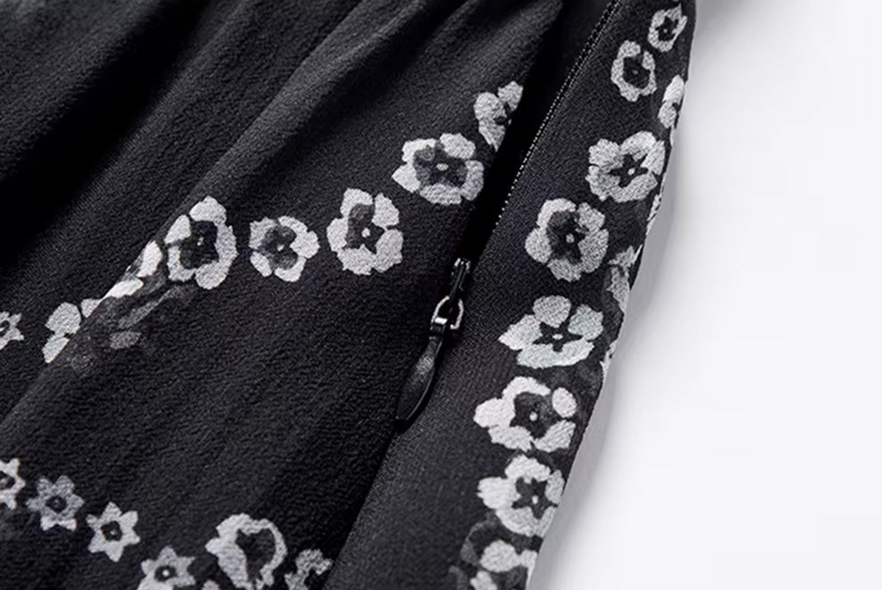 Detailed view of an unzipped invisible zipper integrated into the right side seam of a black silk skirt — From Borcelleclothes.
