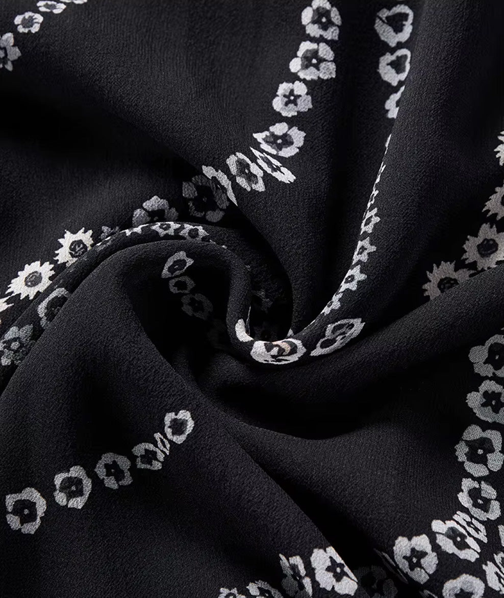 Close-up of the wave-folded texture of a black Mulberry silk skirt in the Marguerite Octaves pattern — From Borcelleclothes.