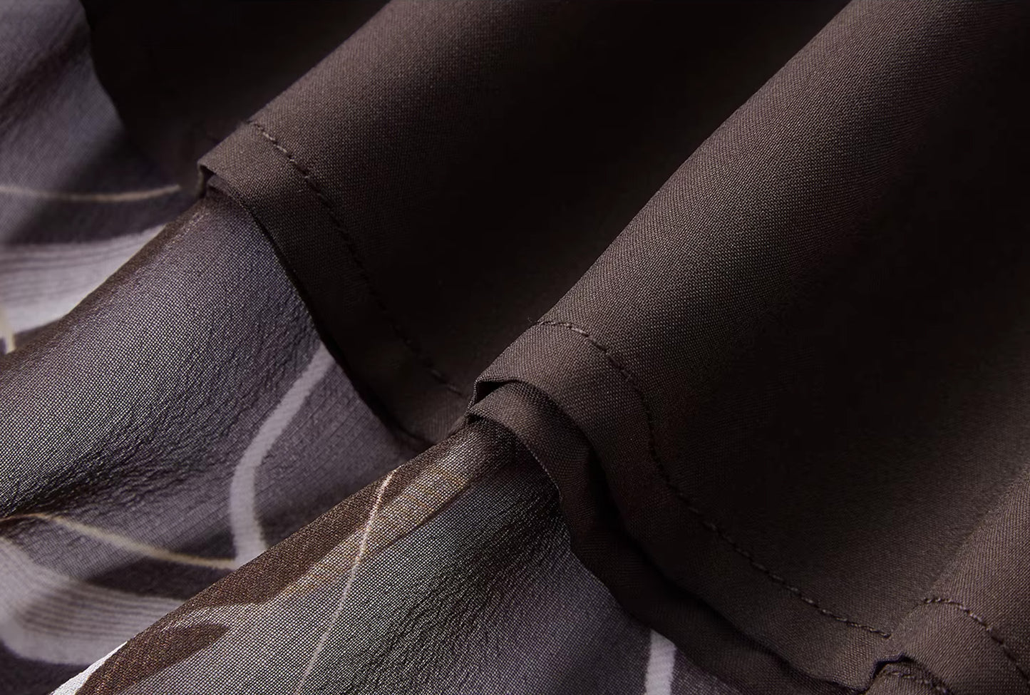 Detailed view of the premium tone-on-tone viscose lining beneath the Café Mirage silk georgette shell — From Borcelleclothes.