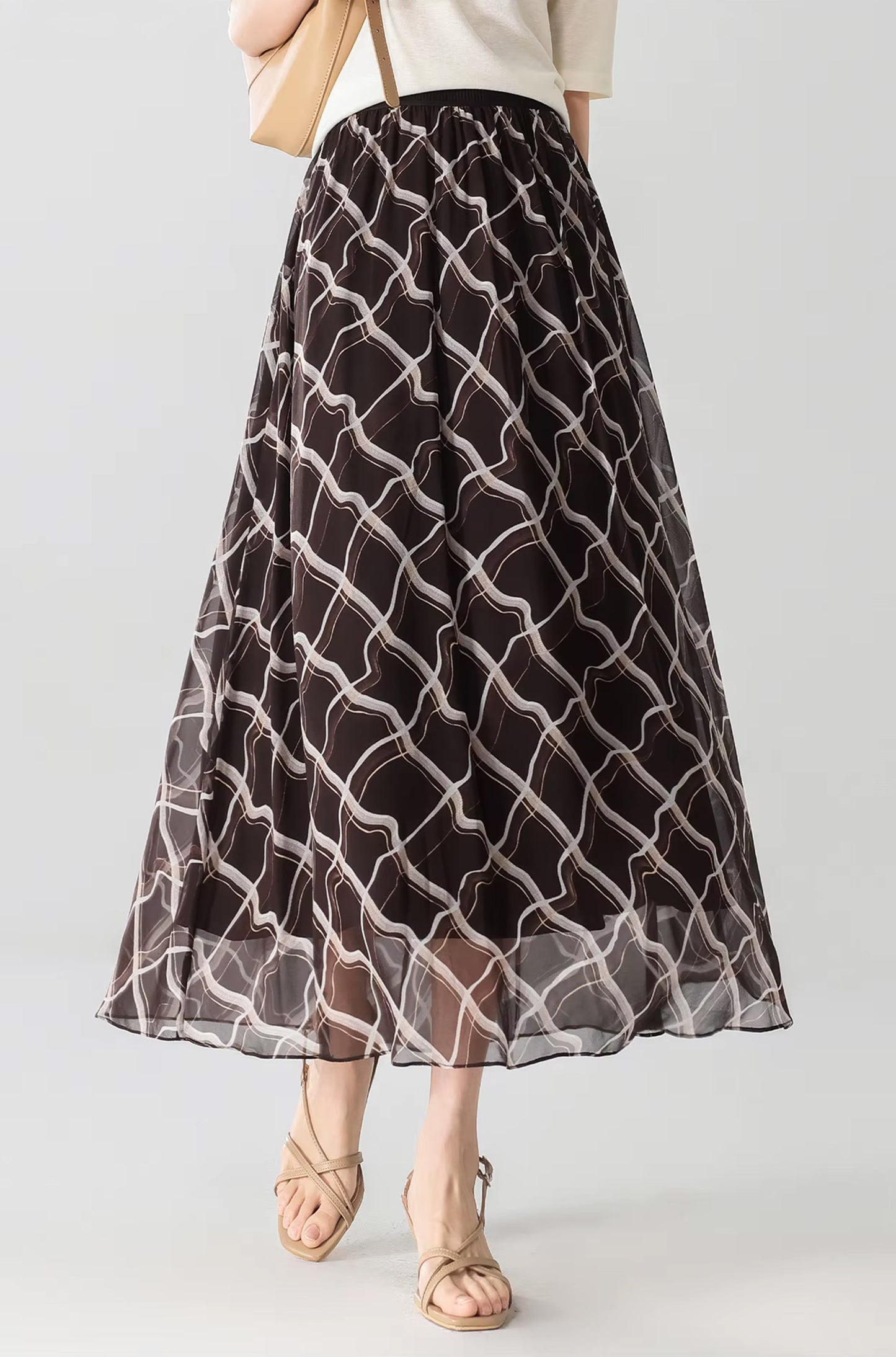 Model wearing the Café Mirage silk rhombus print skirt paired with a shoulder bag — From Borcelleclothes.