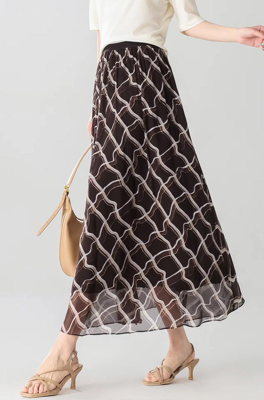 Side view of a model walking in the Café Mirage brown Mulberry silk midi skirt with geometric rhombus print — From Borcelleclothes.